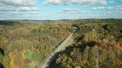 AERIAL: Colorful panorama of Autumn Forest Landscape near rail road