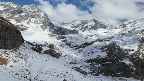 Fly Over Majestic Mountain Peaks in the Alps from a Drone in Winter