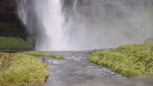 Powerful Waterfall Cascading into Stream