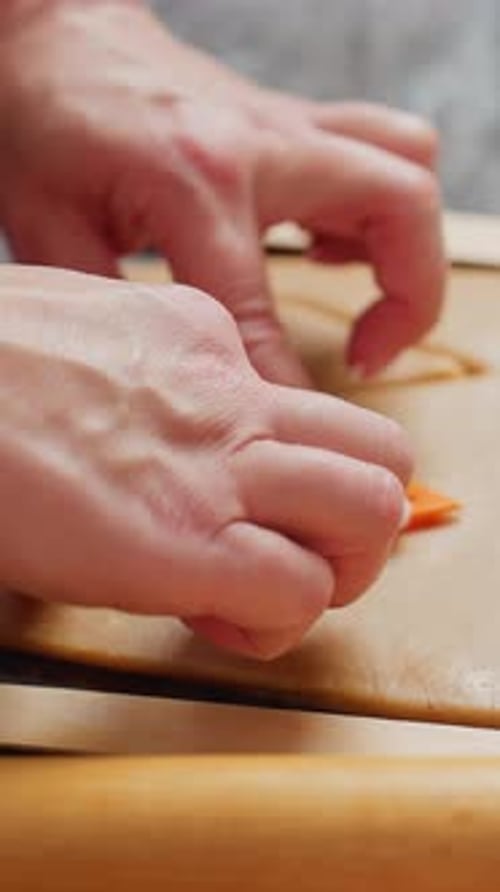 Cutting Dough with Cookie Cutter on Kitchen Counter