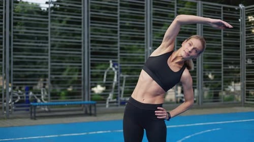 Blonde Woman Stretching Core Muscles Outdoor Gym