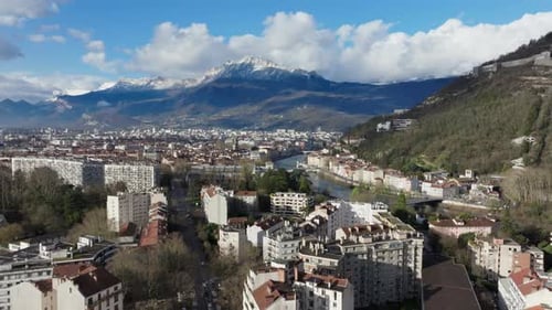 Aerial View of Grenoble Cityscape Revealing Snow Capped French Alps Isere River Urban Landscape with