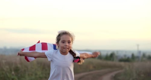 Girl Running with American Flag in a Field