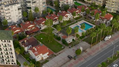 Aerial View Vintage Villas with a Stunning Pool and Palm Trees Sit Gracefully on the Seafront