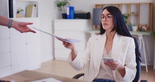 Confident Businesswoman Reviews Financial Documents