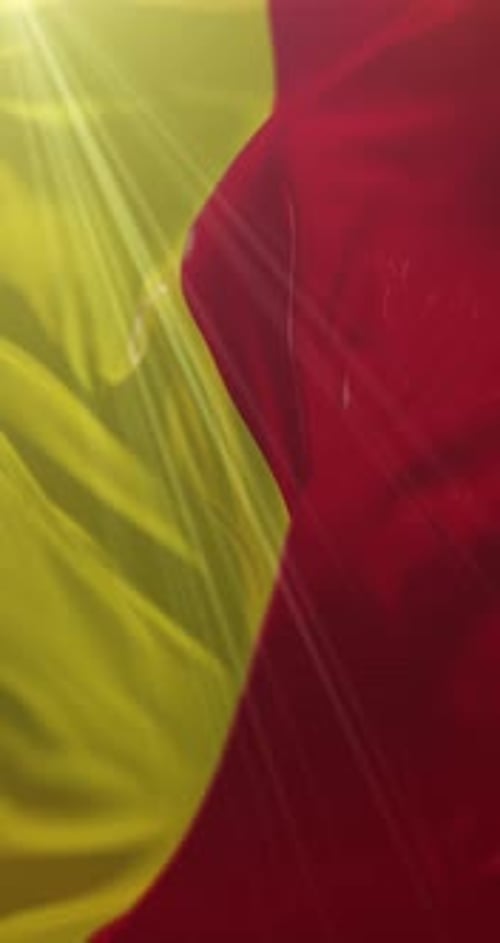 Waving Yellow and Red Vertical Flag with Sun Rays