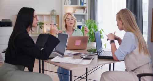 Team Discussing Business in Bright Modern Office