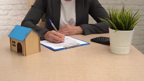Woman Real Estate Agent or Customer Signing Contract to Buy House