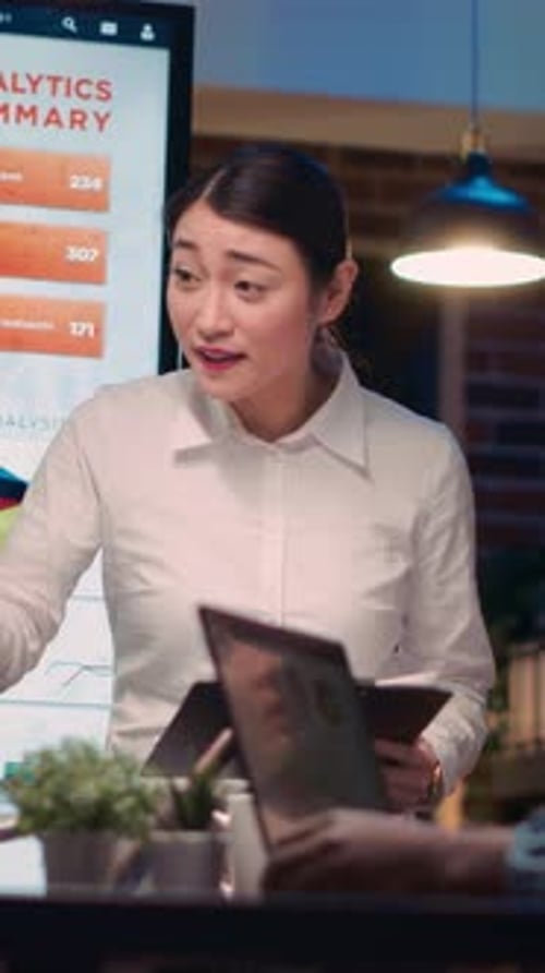 Vertical Video Asian Business Coach Explaining Statistics Graphs Visualization