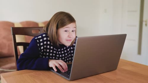 Enthusiastic Child Using Laptop at Home
