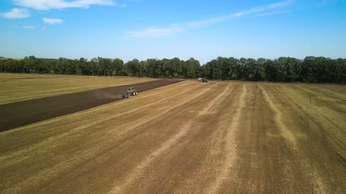 Tractors plowing the field in Ukraine