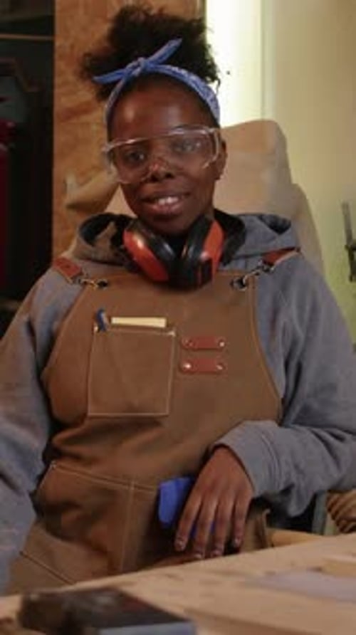 Vertical Portrait of Young Black Woman at Workbench in Carpentry Workshop