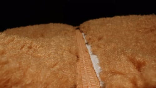 Closing Zipper on Brown, Furry Winter Garment