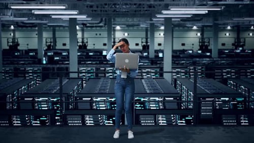Full Body Of Woman Not Satisfied And Shakes Her Head While Using Laptop Computer In Data Center