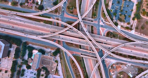Multi-level overpass with lots of cars driving by. Aerial top drone above view