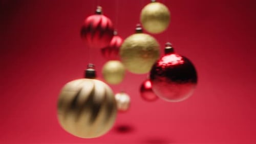 Golden and Red Christmas Ornaments Rotating on Red Background