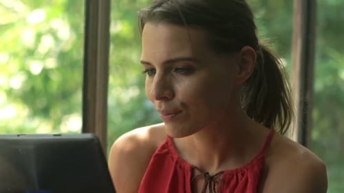 Woman Using Tablet Indoors in Natural Light