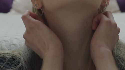 Woman Adjusting Hair and Touching Her Neck