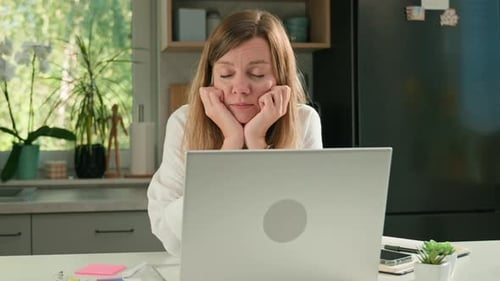 Tired Woman Falling Asleep at Laptop in Home Office