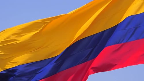 Close up of Columbian flag waving in the wind on bright summer's day