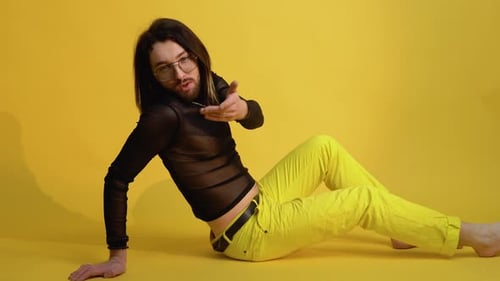 Portrait of a Gay Man or Transgender on a Yellow Background