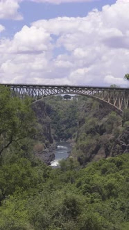 Bridge over the Zambezi River with Victoria Falls in the distance in Zambia