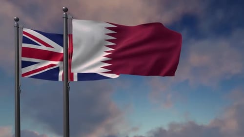 United Kingdom and Qatar Flags Waving in Wind