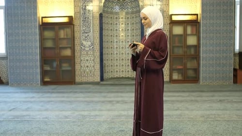 Woman in Mosque with Green Screen Cellphone