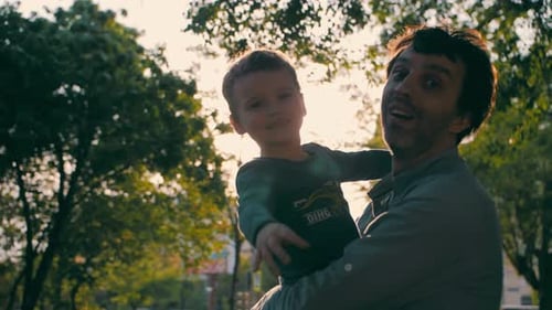 Father with Son Play in the Park in Spring Slow Motion