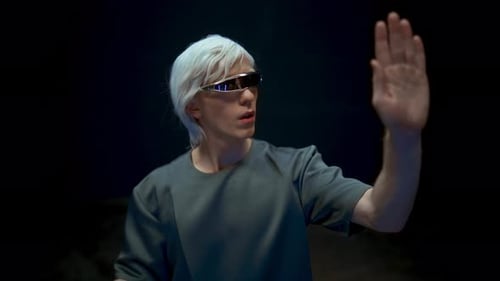Man with white hair touching virtual screen