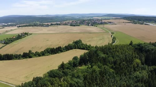 Aerial View From a Drone Fields with a Small Picturesque Town in the Background in a Rural Area