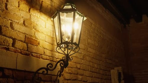 Glowing Venetian Lantern on Old Brick Building Historic Italy Street Atmosphere