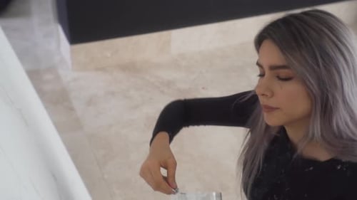 An Attractive Painter Primed Her Canvas Using Palette Knife For Acrylic Paint. - High Angle Shot