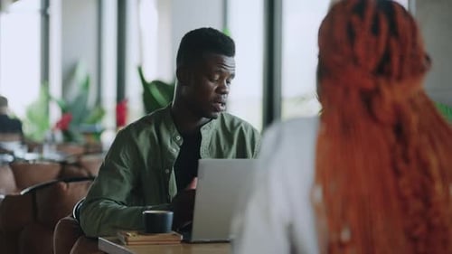 Business Meeting at Cafe with Smiling Afro American Man and Woman Enjoying Fresh Coffee and Leading