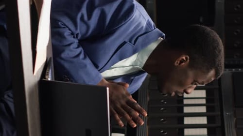 Man Reviewing Documents in a Modern Office