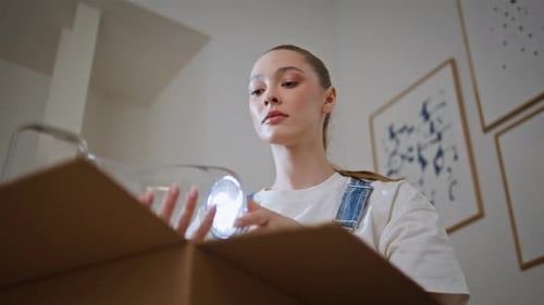 Woman Unboxing Household Items Moving in New Apartment Closeup Lady Unpacking