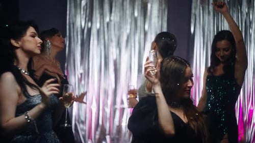 Elegant Women Dancing with Champagne at Nightclub Party