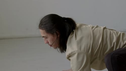 Dancer Doing Dynamic Warmup Stretch in Studio
