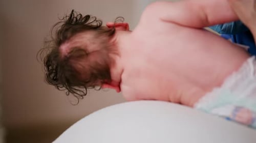 Crying Baby on Examination Table at Hospital