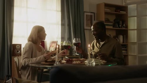 Couple Eating and Drinking Wine at Home
