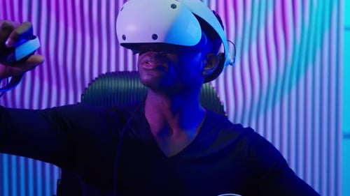 Man Wearing VR Headset Sitting in Modern Chair