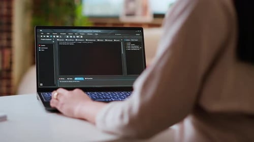 Asian Female Programmer Works on Coding Software in a Home Office Setup