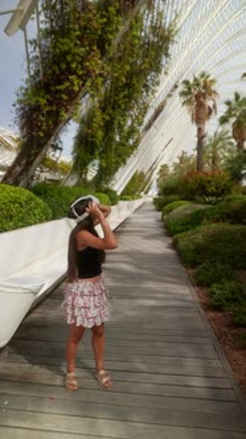 A Woman is Exploring a Modern Park While Immersed in an Augmented Reality Experience