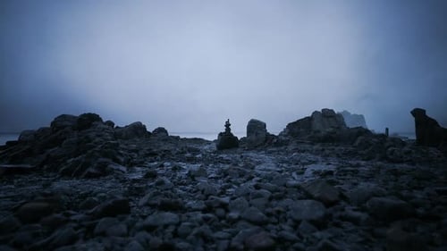 Rock Formation at Twilight Near a Coastal Area with a Misty Atmosphere