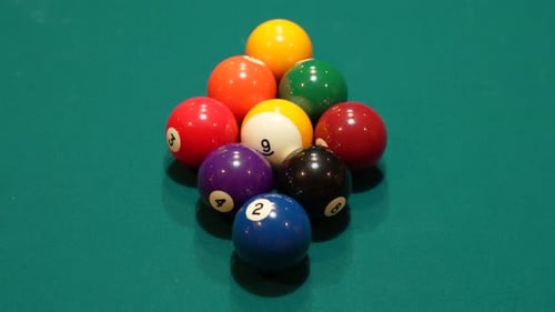 Pool Balls are Broken on a 9 Ball Diamond Rack Closeup on the Spot with Solid and Striped Billiard B