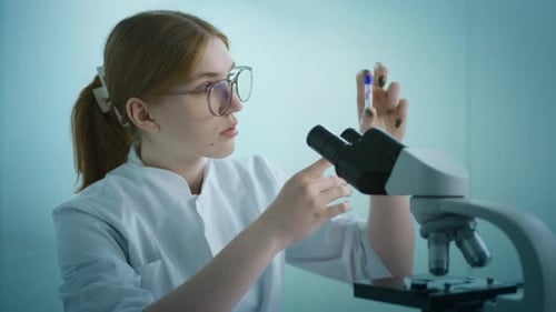 Young Scientist Examines Test Tube in Laboratory