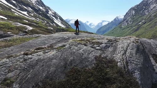 Hiker Enjoying Beautiful Landscape of Norwegian Mountains