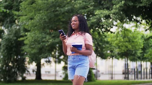 Smiling Woman Talking on Phone in Park