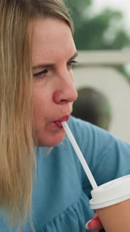 Woman Drinking Chocolate Beverage with Focused Expression