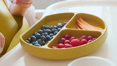 Toddler Enjoys Fresh Fruit Snack at Home